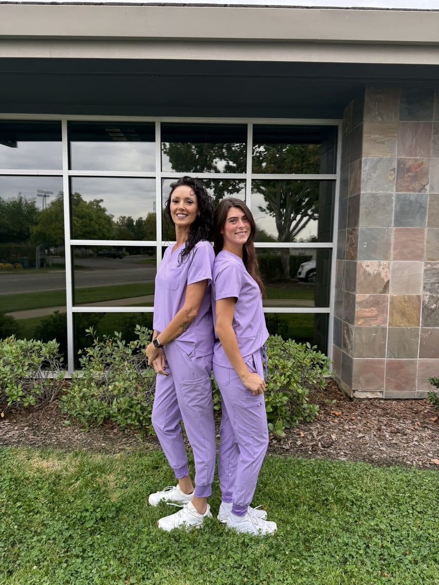 Two Athena caregivers in lavender scrubs